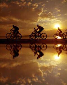 Image of sporty company six friends on bicycles outdoors against