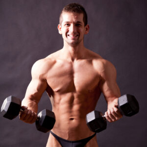 young bodybuilder traininig over balck background